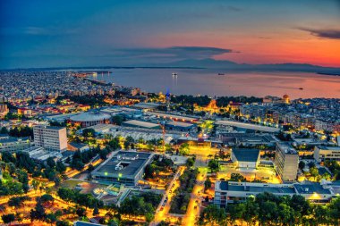 Selanik, Yunanistan - Haziran 175 2021: Kuzey Yunanistan 'daki üniversiteler ve HELEXPO Uluslararası Sergi Merkezi' nden günbatımında Selanik kentinin hava manzarası
