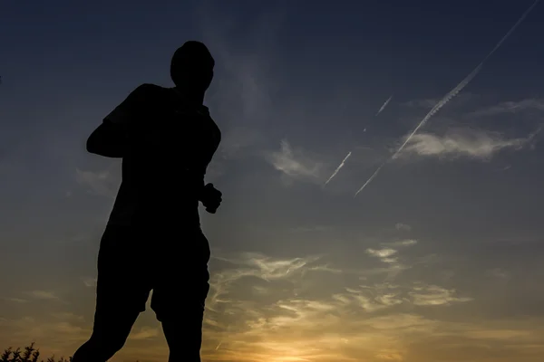 Silhouettes of Man running in sunset — Stock Photo, Image