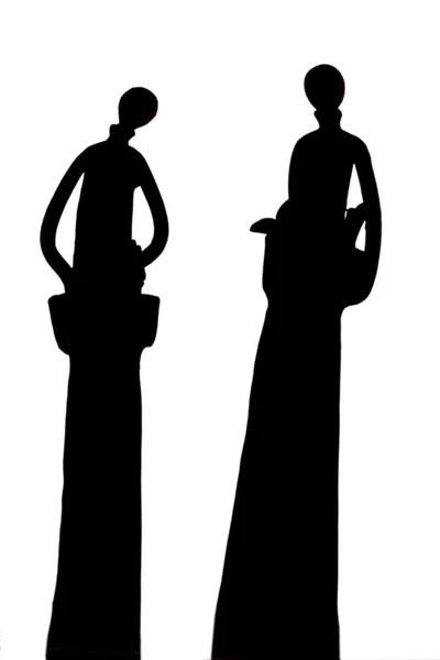 Silhouettes of Tall decorative metal dolls — Stock Photo, Image