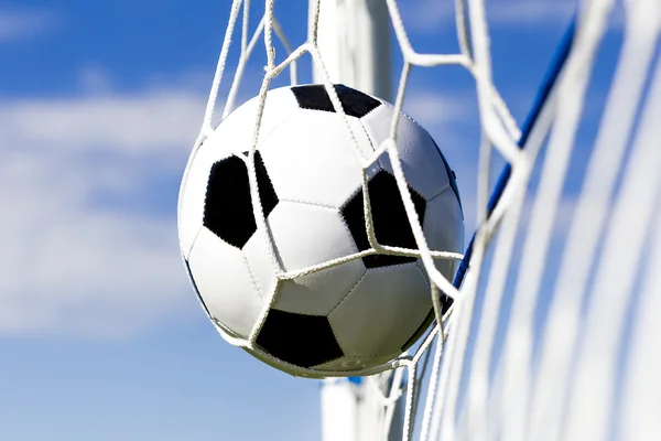 Soccer football in Goal net with sky field. — Stock Photo, Image