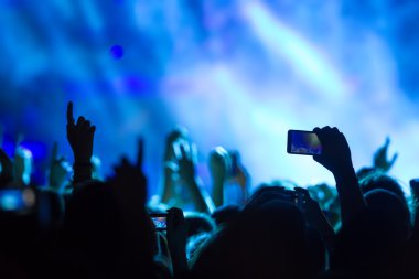 Bir müzik sırasında dokunmatik akıllı telefon ile fotoğraf çekmeye kişi 