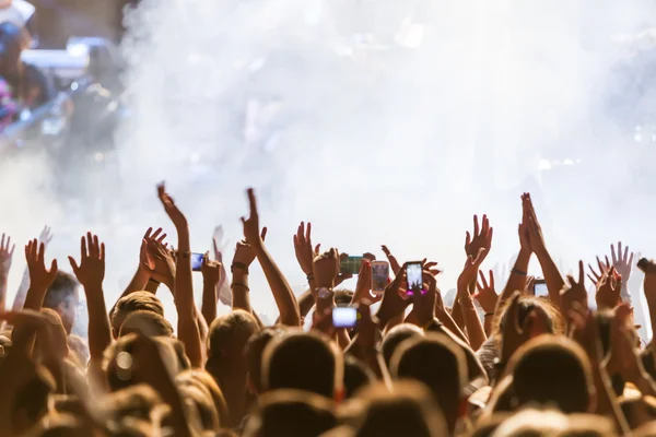 People taking photographs with touch smart phone during a music — Stock Photo, Image