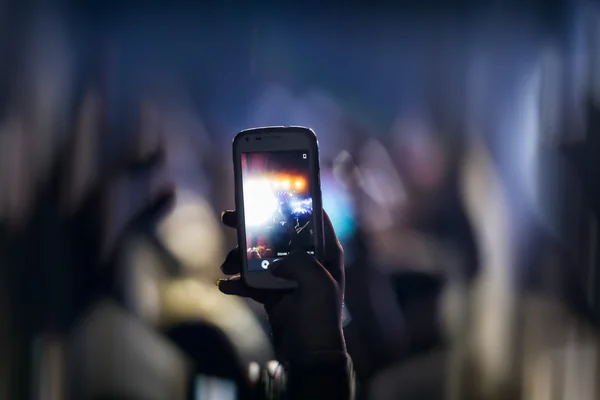 People taking photographs with touch smart phone during a music — Stock Photo, Image