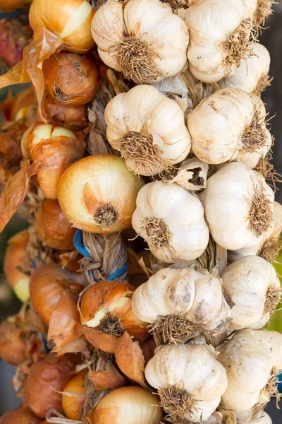 Hanging bunch bundle of onion and garlic clove — Stock Photo, Image