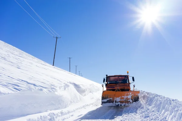 Snowmobile moving snow to clear the roads in Falakro ski center, — Stock Photo, Image