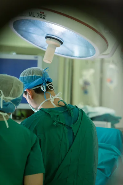 Team of doctors operates at patient in clinic center — Stock Photo, Image