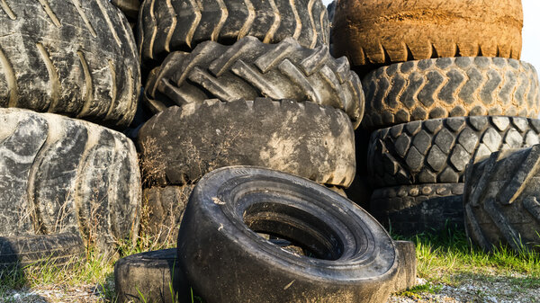 Numerous tires stacked on top of each other