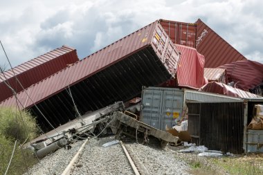 Derailed train coaches at the site of a train accident at the Ge clipart