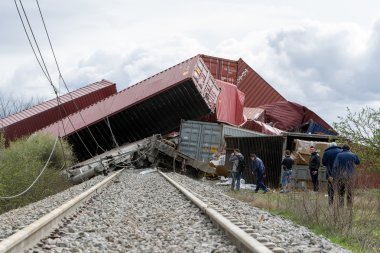 Derailed train coaches at the site of a train accident at the Ge clipart