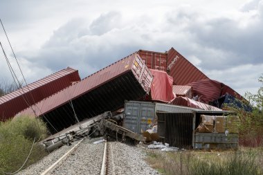 Derailed train coaches at the site of a train accident at the Ge clipart
