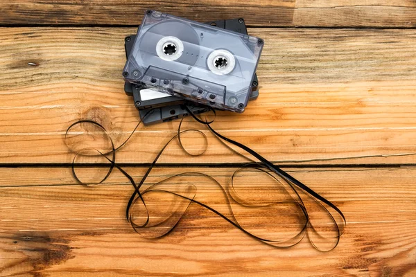 Vintage audio cassette with loose tape shaping two hearts on a w — Stock Photo, Image