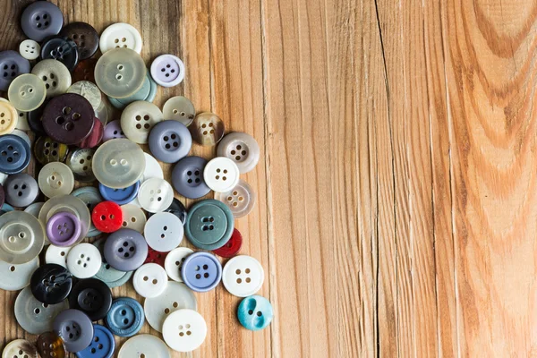 Colored buttons on wooden board, Colorful buttons, on old wooden — Stock Photo, Image