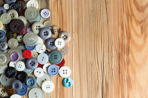 Colored buttons on wooden board, Colorful buttons, on old wooden — Stock Photo, Image