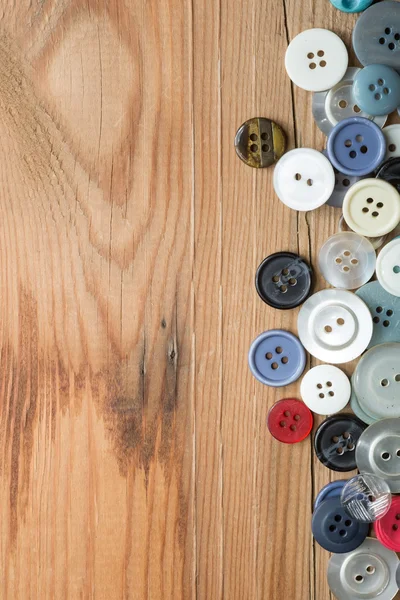 Colored buttons on wooden board, Colorful buttons, on old wooden — Stock Photo, Image