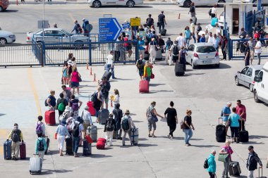 Passengers disembark from the ship at the port of Paros in Greec clipart