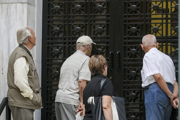 Fila de aposentados fora de uma sucursal do Banco Nacional como bancos apenas op — Fotografia de Stock