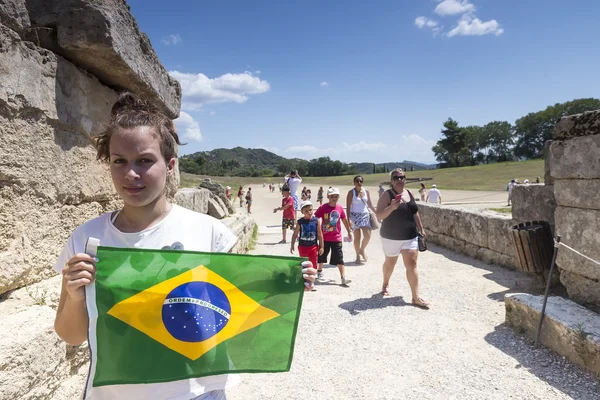 Girl holds the Brazilian flag for the next Olympics at Olympia b — Stock Photo, Image