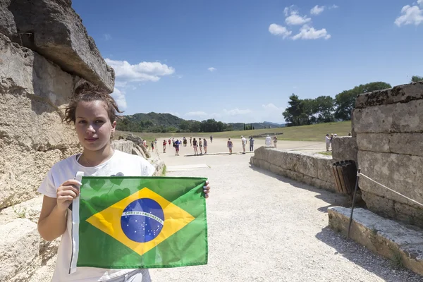Girl holds the Brazilian flag for the next Olympics at Olympia b — Stock Photo, Image