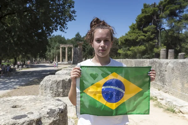 Girl holds the Brazilian flag for the next Olympics at Olympia b — Stock Photo, Image