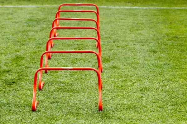 Soccer (football) training equipment on the green field of the s — Stock Photo, Image