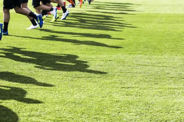 The feet of the players of Paok with their shadows during team p — Stock fotografie