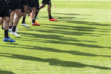 The feet of the players of Paok with their shadows during team p