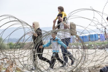 Hundreds of immigrants are in a wait at the border between Greec clipart