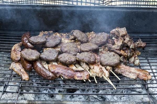 Various meats like chicken, sausage, steak and corn wrapped in a — Stock Photo, Image