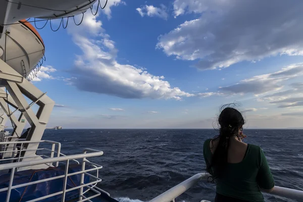 Rear view of a woman on the deck of a ship. — Stock Photo, Image