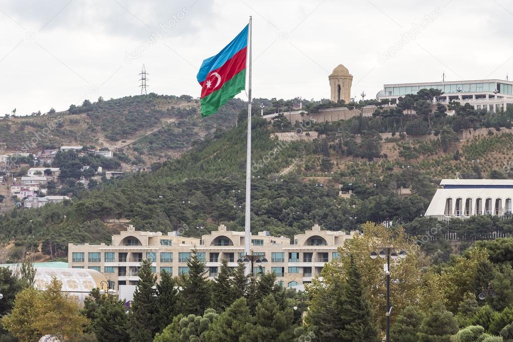 Azerbaijan flag waving on the wind in front of the city