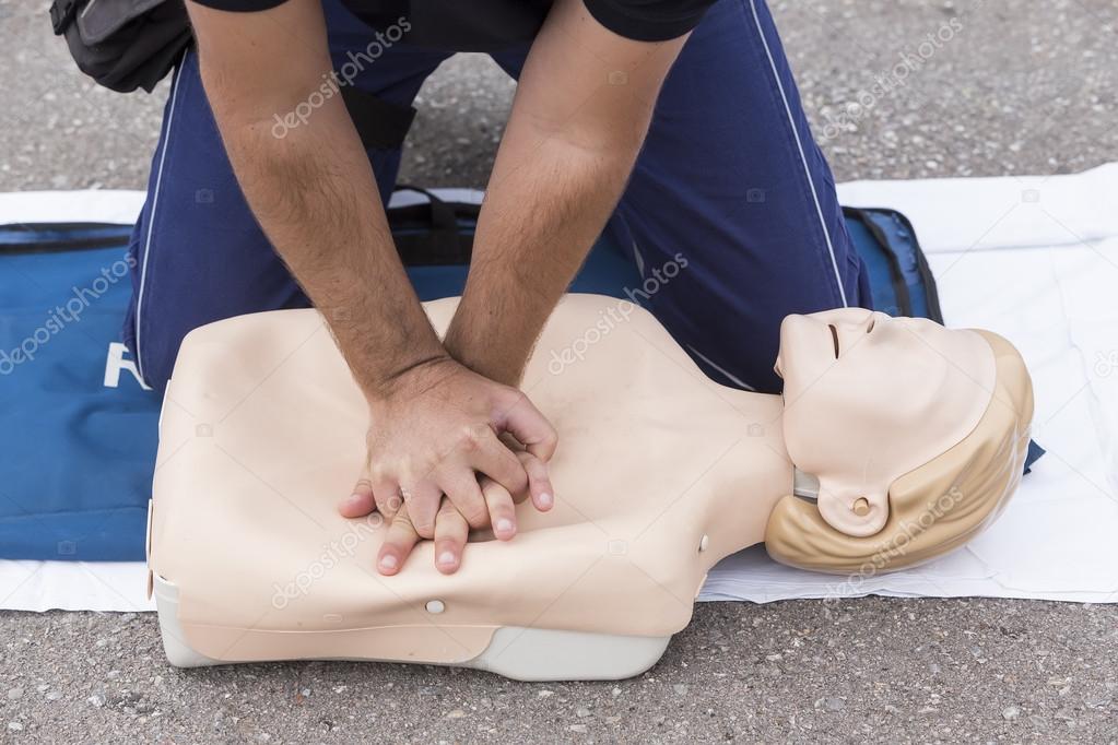 man instructor showing CPR on training doll
