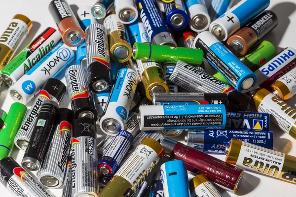 Different types of used batteries ready for recycling lying in a — Stock Photo, Image