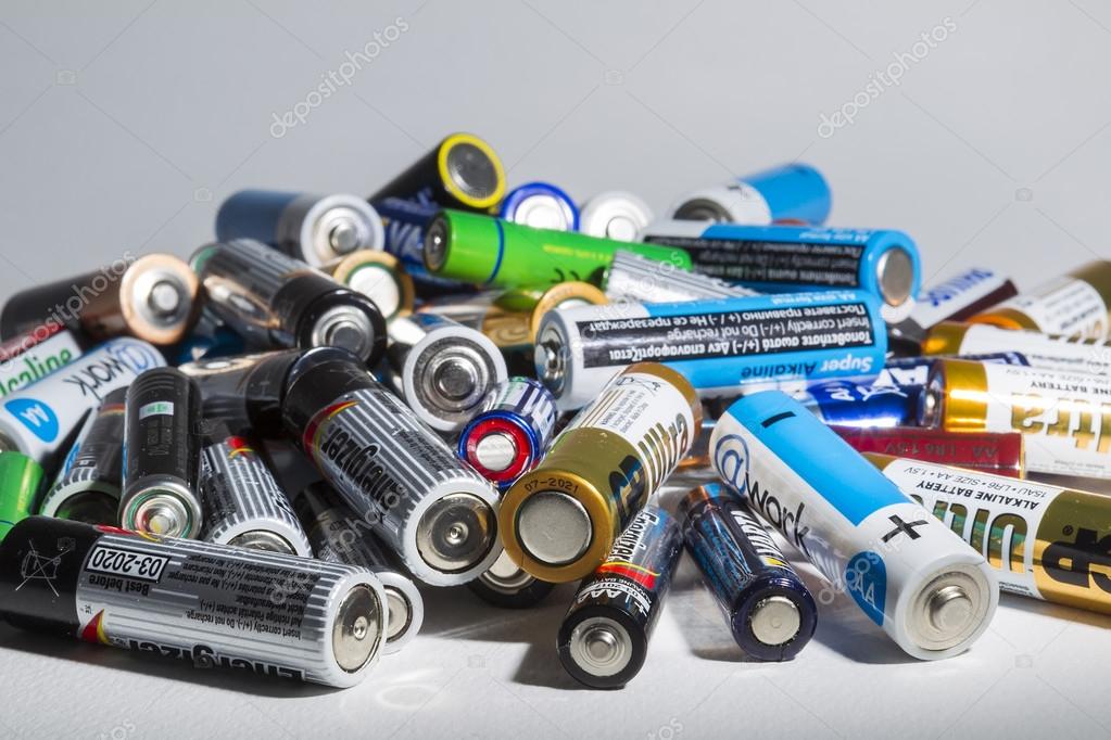 Different types of used batteries ready for recycling lying in a Stock Editorial Photo