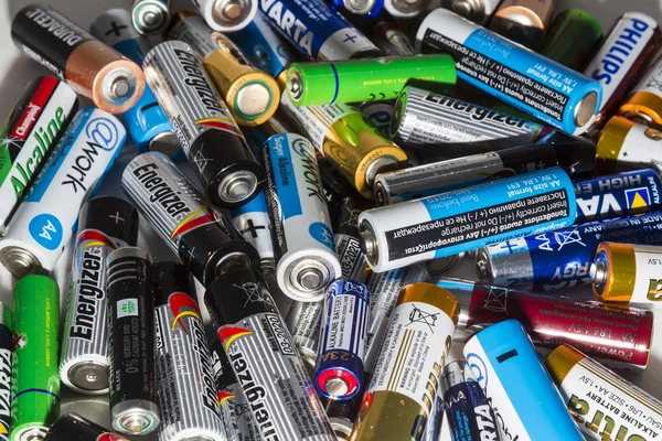 Different types of used batteries ready for recycling lying in a — Stock Photo, Image