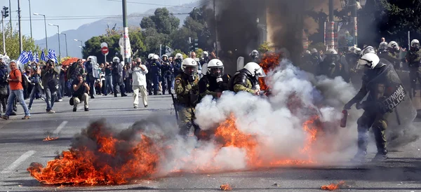 Clashes have broken out between riot police and youths at a demo