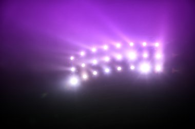 Sis ile parlak beyaz ve sarı stadyum ışıkları 