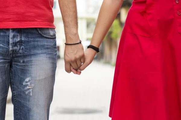 Giovane coppia che si tiene per mano sulla strada insieme — Foto Stock