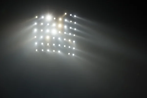 Luzes brancas e amarelas brilhantes do estádio com nevoeiro — Fotografia de Stock