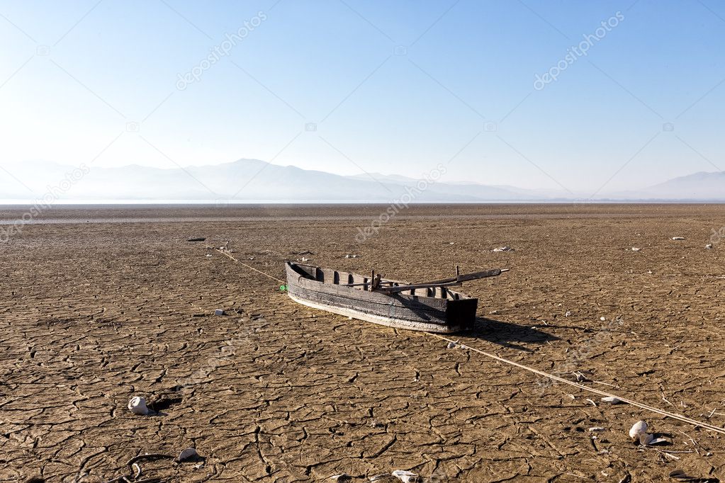 Dry lake bed with natural texture of cracked clay in perspective