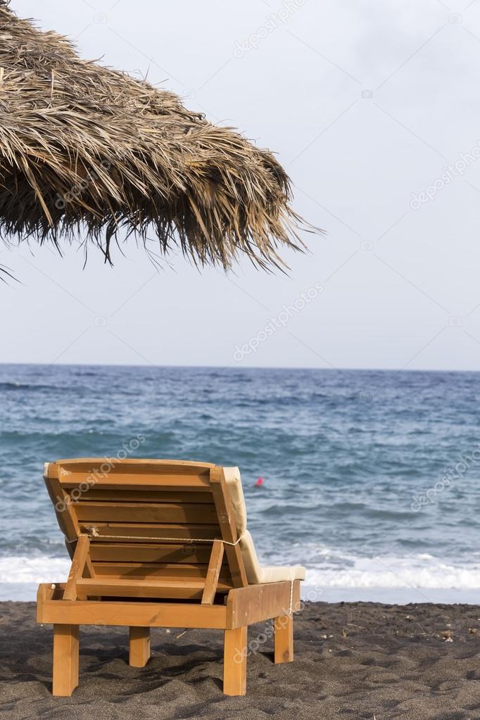 view of Perissa beach on the Greek island of Santorini with sunb