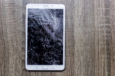Kırık cam tablet grunge ahşap üzerine. Seçici odak. Düşük 