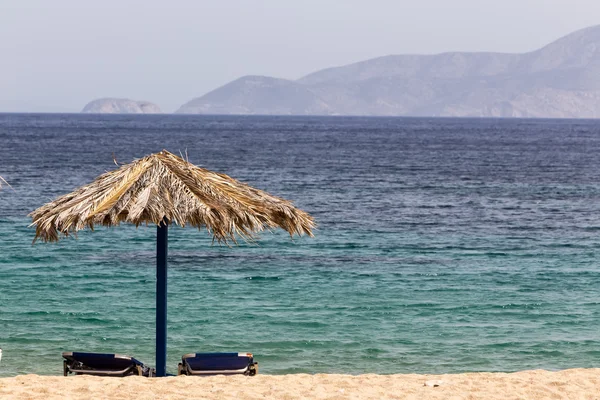 Blå havet, gyllene sand, solstolar och parasoller på stranden. IOS jag — Stockfoto