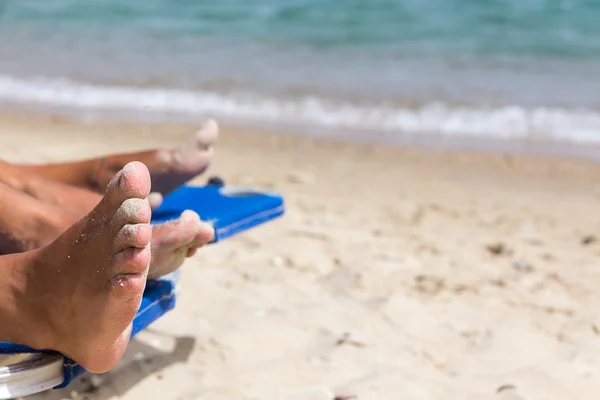 Pies de arena en la playa. Fondo de vacaciones — Foto de Stock