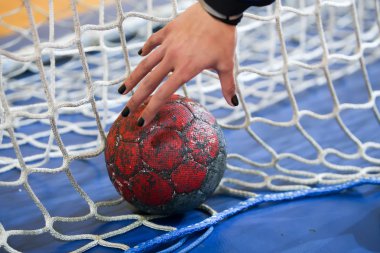 Undefined hands holding a ball prior to the Greek Women Cup Fina