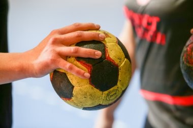 Undefined hands holding a ball prior to the Greek Women Cup Fina