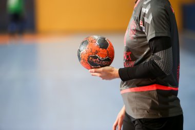 Undefined hands holding a ball prior to the Greek Women Cup Fina