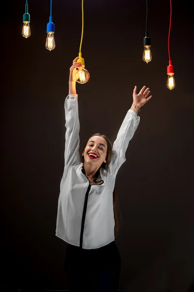 Girl hanging holding with hand illuminated retro lamp — Stock Photo, Image
