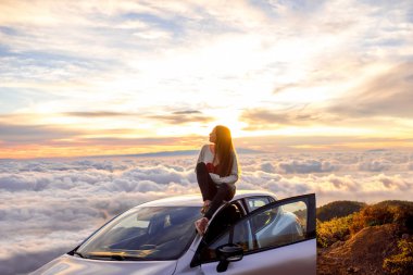 Woman enjoying beautiful cloudscape