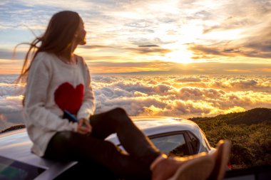 Woman enjoying beautiful cloudscape