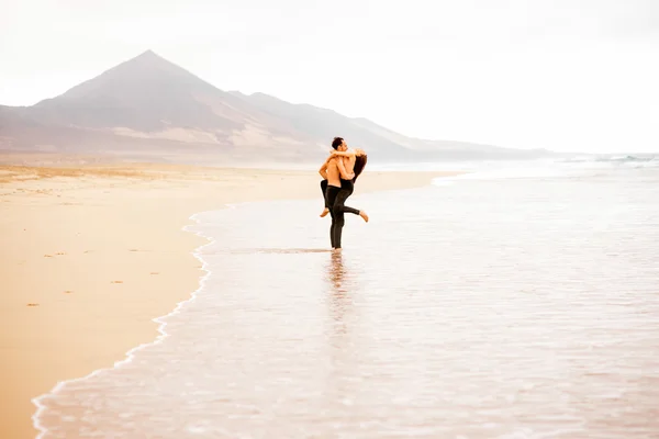 Couple avec torse nu sur la plage — Photo